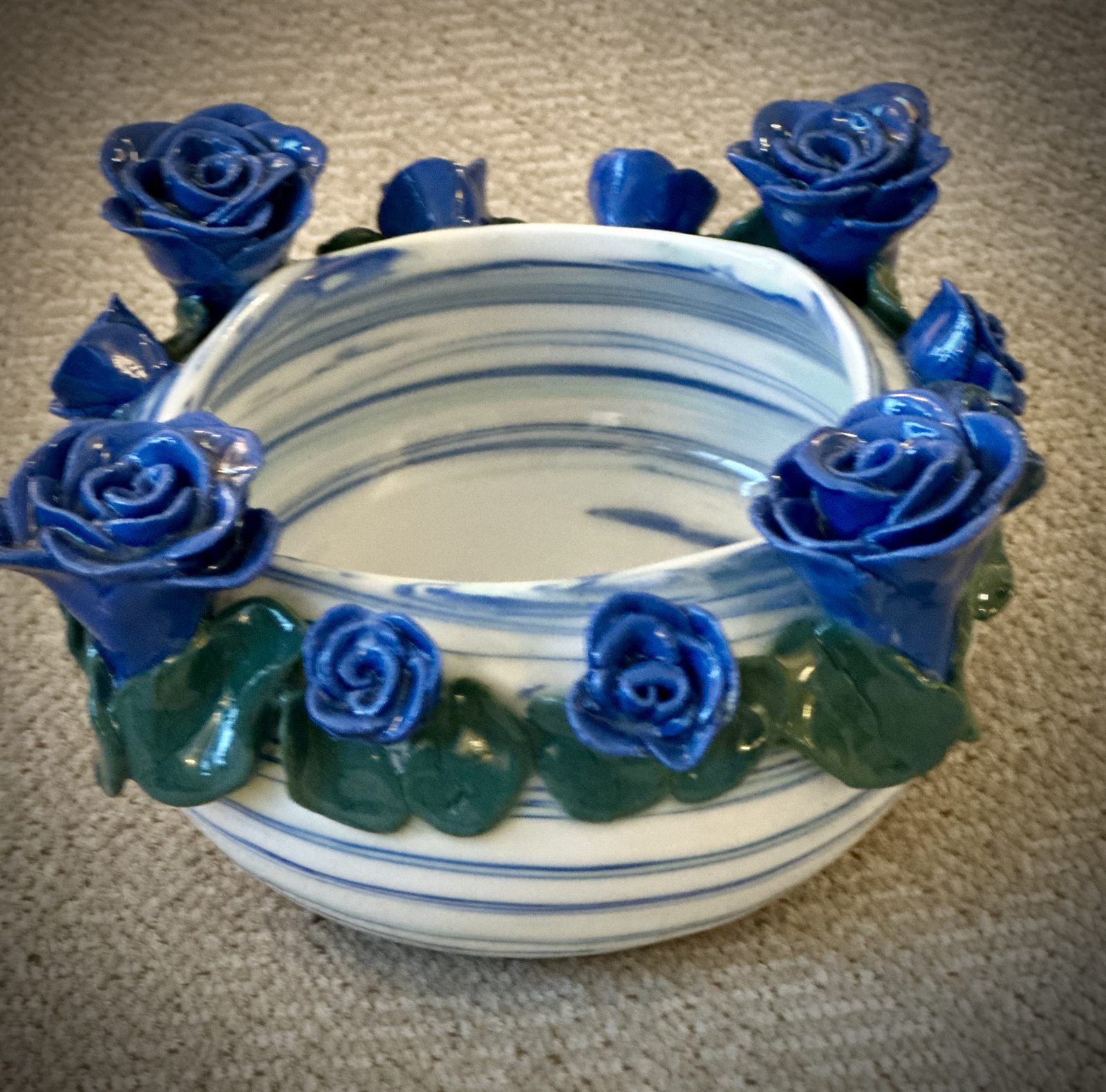 Cobalt roses and deep green leaves ringing a blue-and-white marbled bowl